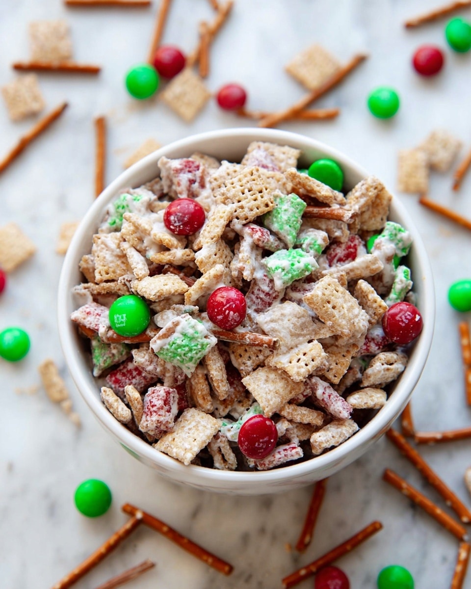 A white bowl filled with a mix of tiny square cereal pieces, thin brown pretzel sticks, and round candy-coated chocolates in red and green colors. The snack mix is lightly coated with a white, creamy layer that makes it look sticky and clumpy. Around the bowl on a white marbled texture are scattered pretzel sticks, cereal pieces, and red and green round candies matching those inside the bowl. The overall look is colorful and crunchy with a festive feel. photo taken with an iphone --ar 4:5 --v 7