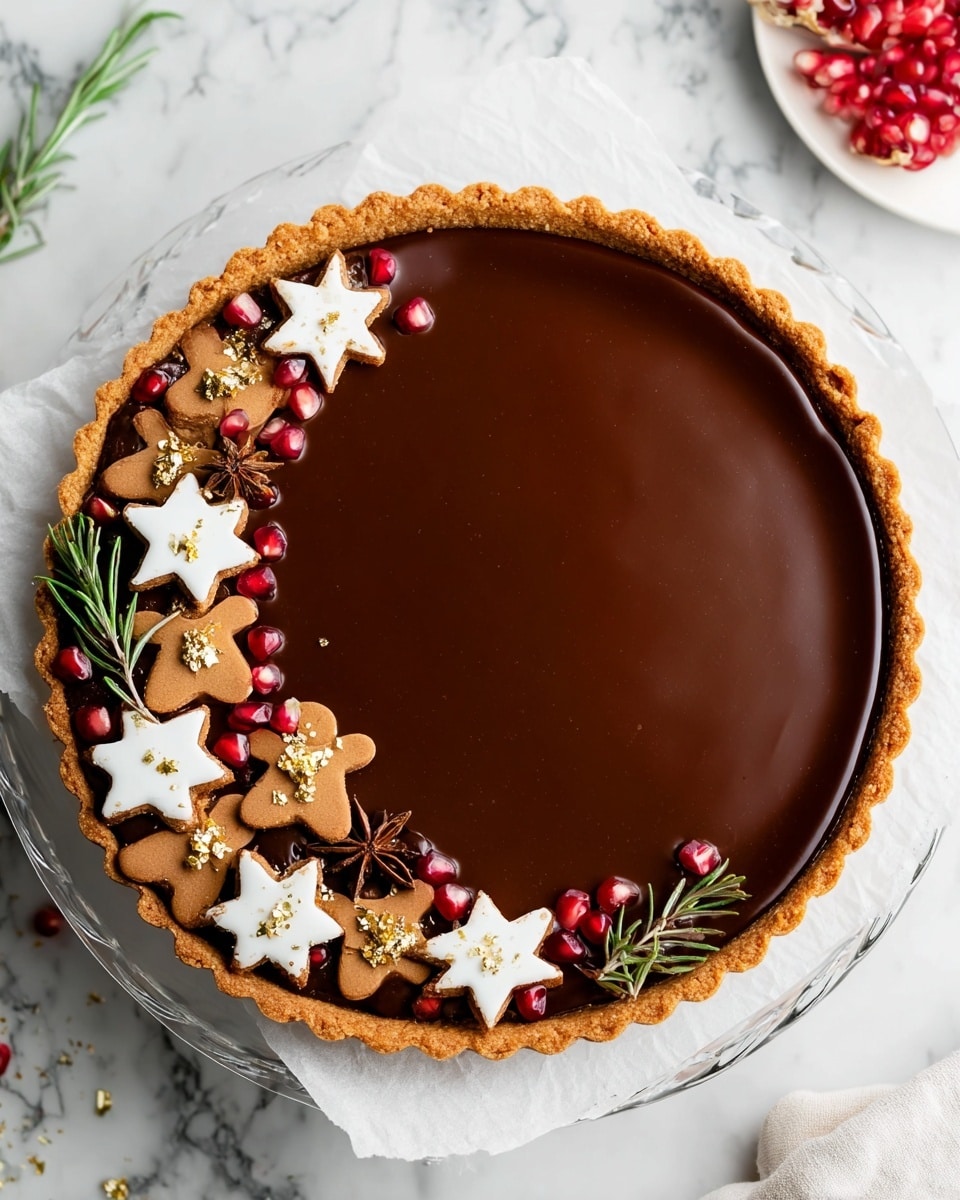 A round tart with a golden brown crust at the bottom and sides, filled with a smooth and shiny dark chocolate layer covering the entire top. On one side of the tart, there is a decorative border made of small white star-shaped cookies with smooth icing, brown gingerbread men with white icing details, dark brown star anise, bright red pomegranate seeds, small green rosemary sprigs, and tiny gold leaf pieces arranged closely together. The tart is placed on a white paper on a clear glass plate resting on a white marbled surface. Photo taken with an iphone --ar 4:5 --v 7