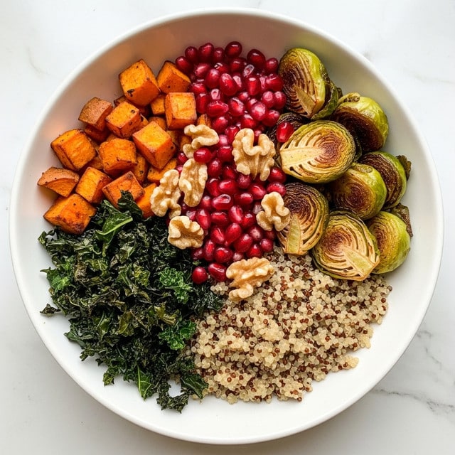 A white bowl filled with a colorful layer of different foods arranged separately. The base layer is a light mix of fluffy quinoa grains, topped with bright orange cubes of roasted sweet potato on one side. Roasted Brussels sprouts with a browned, crispy texture occupy another side, while there is a small pile of dark green, finely chopped kale mixed with herbs on another part of the bowl. In the center, there is a small mound of shiny, deep red pomegranate seeds mixed with crunchy golden-brown walnuts scattered on top, with a few pumpkin seeds also visible. The bowl is placed on a white marbled surface. photo taken with an iphone --ar 4:5 --v 7