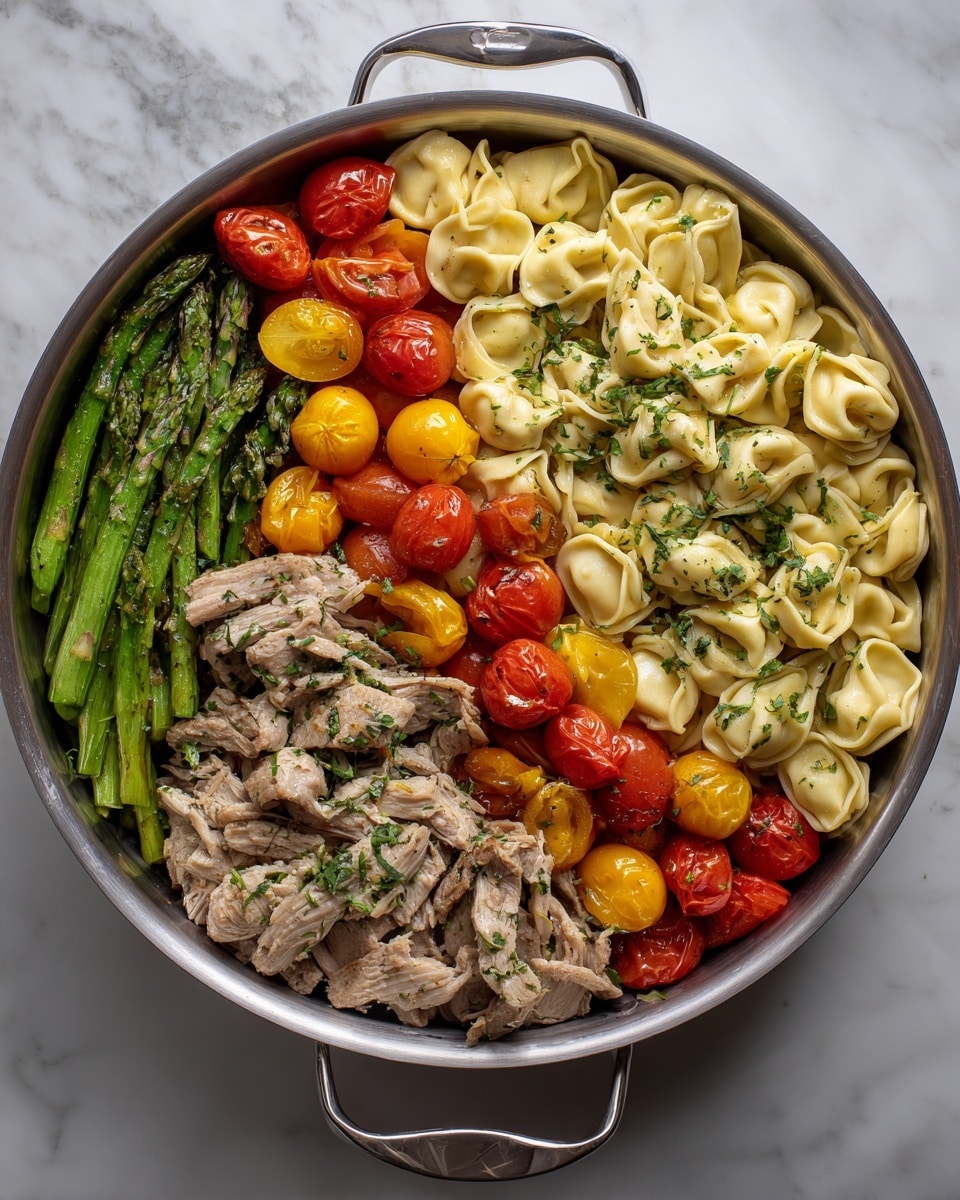 The image shows a skillet with three main sections of food arranged side by side. On the top right, there are light beige tortellini pasta pieces with a slightly glossy texture, coated with herbs. On the left side, there are bright green asparagus stalks cooked to a tender but firm texture, mixed with whole and halved small cherry tomatoes in red and yellow colors, adding pops of brightness. The bottom right section features pieces of cooked chicken that are golden-brown with herbs and spices, topped with more halved red and yellow cherry tomatoes. The skillet is placed on a white marbled surface. Photo taken with an iphone --ar 4:5 --v 7