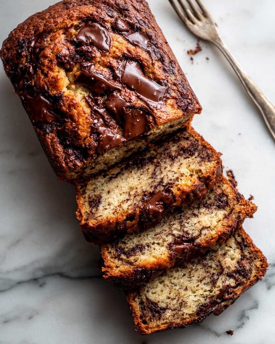 A loaf of chocolate chip banana bread is shown on a white marbled surface, partially sliced with three visible slices. The bread has a golden-brown crust with large chunks of melted chocolate embedded on top and through the soft, moist interior. The texture inside appears light and airy with pieces of chocolate spread unevenly throughout. It rests on a white cloth beneath it. Photo taken with an iphone --ar 4:5 --v 7