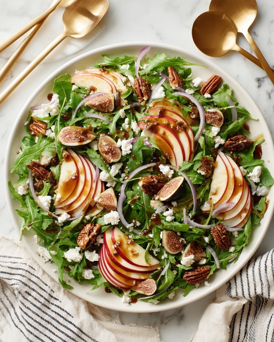 A white plate filled with a fresh salad on a white marbled surface shows a bed of green arugula leaves as the base layer. On top, thin slices of red apple with white flesh are arranged in small stacks around the plate. Whole pecan nuts are scattered evenly, dark brown with a shiny texture. Small pieces of chopped figs add a darker brown color and rough texture. Thin strips of purple-red onion and small crumbles of white feta cheese are sprinkled all over, finishing with a light drizzle of brown dressing that adds a slight shine. Photo taken with an iphone --ar 4:5 --v 7